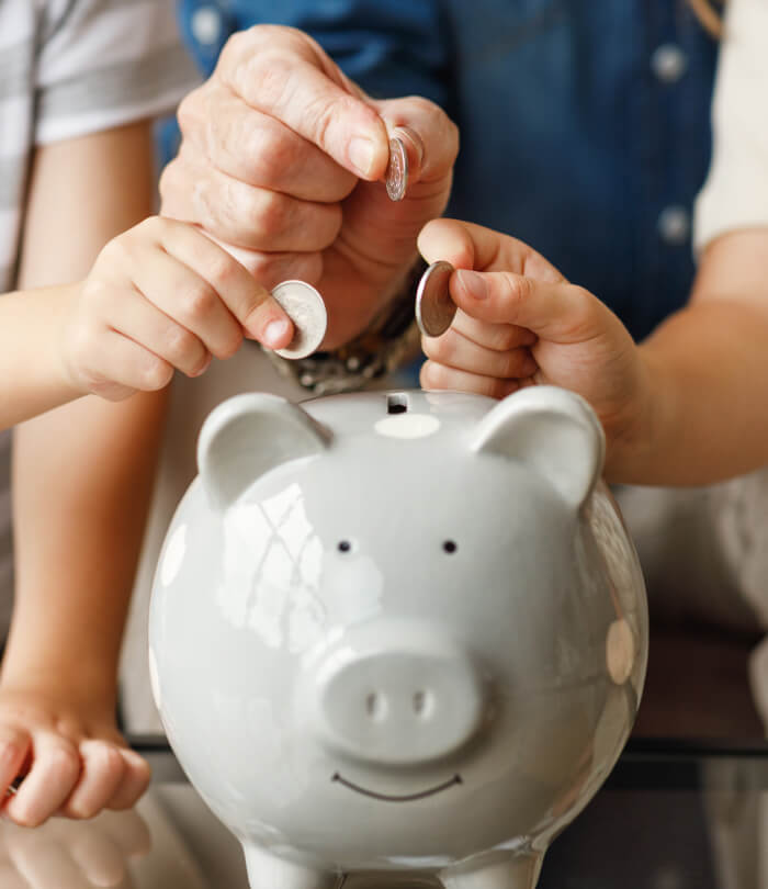 Grandfather and grandchildren saving money