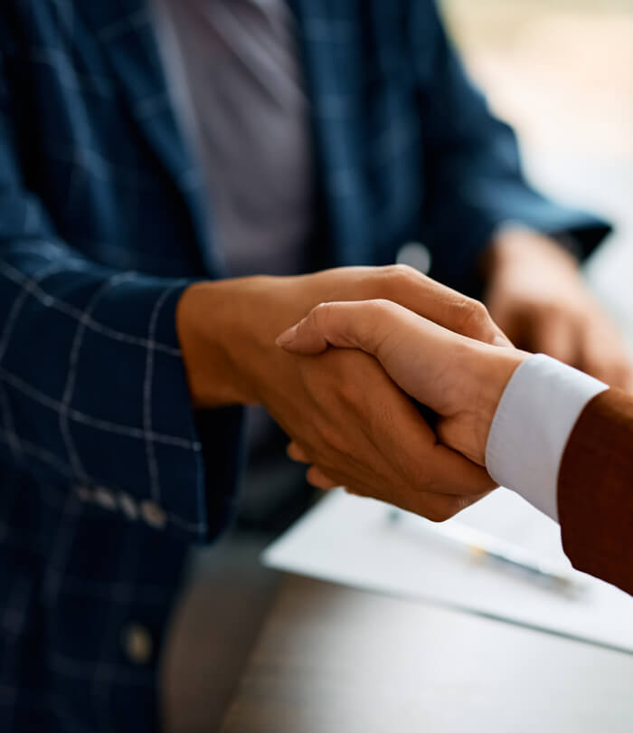 Close-up of business people shaking hands in the office