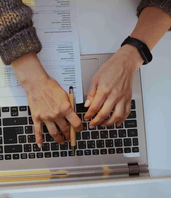 Person with documents and laptop working