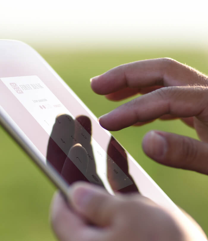 Young farmer logging into My First Bank Mobile App on a tablet.