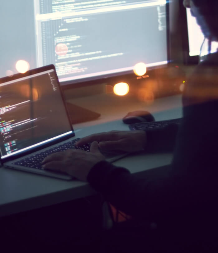 Hacker in front of monitors