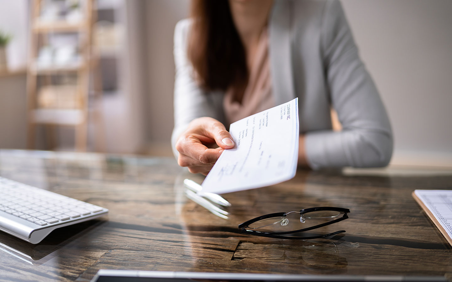 Lady holding paper check