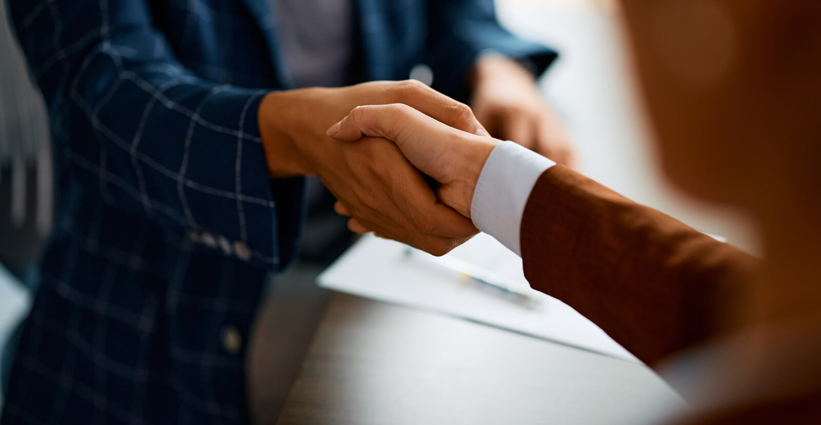 Close-up of business people shaking hands in the office